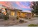 Welcoming home with desert landscaping, covered porch, and attached two-car garage at 22639 E Avenida Del Valle --, Queen Creek, AZ 85142