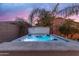 Tranquil backyard featuring a hot tub, palm trees, and privacy fencing at 22639 E Avenida Del Valle --, Queen Creek, AZ 85142