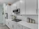 Modern kitchen features white cabinets, quartz countertops and stainless steel appliances at 22639 E Avenida Del Valle --, Queen Creek, AZ 85142