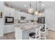 Stylish kitchen boasts granite counters, white cabinets, and pendant lighting at 22639 E Avenida Del Valle --, Queen Creek, AZ 85142