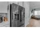 Kitchen with modern stainless steel fridge and living room view at 22639 E Avenida Del Valle --, Queen Creek, AZ 85142
