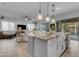 Kitchen island featuring an undermount sink and pendant lighting with living space view at 22639 E Avenida Del Valle --, Queen Creek, AZ 85142