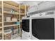 Functional laundry room with washer, dryer, and ample shelving for storage at 22639 E Avenida Del Valle --, Queen Creek, AZ 85142