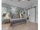 Bright primary bedroom with sliding barn door to bath and natural lighting at 22639 E Avenida Del Valle --, Queen Creek, AZ 85142