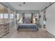 A spacious and inviting main bedroom with ensuite bathroom access through a sliding barn door and plank flooring at 22639 E Avenida Del Valle --, Queen Creek, AZ 85142