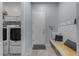 Well organized mud room features washer, dryer, hooks, and bench at 22639 E Avenida Del Valle --, Queen Creek, AZ 85142