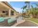 Stunning backyard pool area with a rock waterfall, lush tropical landscaping, and lounge chairs at 22639 E Avenida Del Valle --, Queen Creek, AZ 85142