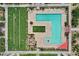A top-down perspective of a community pool featuring unique design, ample seating, and landscaping at 22639 E Avenida Del Valle --, Queen Creek, AZ 85142