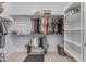 Organized walk-in closet with clothing racks and shelving provides ample storage space and a bench for sitting at 22639 E Avenida Del Valle --, Queen Creek, AZ 85142