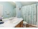 Bright bathroom features a vanity with sink, toilet, and shower with curtain at 2400 E Baseline Ave # 169, Apache Junction, AZ 85119
