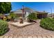 Charming home featuring a well-maintained front yard with desert landscaping and decorative wishing well at 2400 E Baseline Ave # 169, Apache Junction, AZ 85119