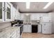 Well-lit kitchen boasts white cabinets, granite countertops, stainless steel appliances, and a practical design at 2400 E Baseline Ave # 169, Apache Junction, AZ 85119