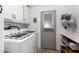 Functional laundry room with washer, dryer, and ample cabinet space at 2400 E Baseline Ave # 169, Apache Junction, AZ 85119