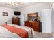 Comfortable main bedroom features a ceiling fan, dresser, and doorway at 2400 E Baseline Ave # 169, Apache Junction, AZ 85119