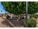 Landscaped yard and outdoor sitting area with a brick paver retaining wall at 2400 E Baseline Ave # 169, Apache Junction, AZ 85119