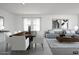 Bright open-concept living area with modern furnishings, stylish decor, and a large sectional sofa at 24233 W Hidalgo Ave, Buckeye, AZ 85326