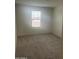 Neutral bedroom with standard window, plush carpeting and white walls at 24268 W Pecan Rd, Buckeye, AZ 85326