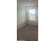 Bedroom featuring neutral carpet, white walls, and one window offering natural light at 24268 W Pecan Rd, Buckeye, AZ 85326