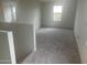 Bright bonus room with neutral carpet and large window with views of the surrounding landscape at 24268 W Pecan Rd, Buckeye, AZ 85326