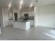Modern kitchen with an island, granite countertops, and stainless steel appliances at 24268 W Pecan Rd, Buckeye, AZ 85326