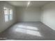 Bright, carpeted living room with ample natural light from large windows at 24268 W Pecan Rd, Buckeye, AZ 85326
