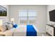 Minimalist bedroom featuring plush bedding, modern decor, and ample natural light creating a relaxing atmosphere at 25484 W Graham Trl, Buckeye, AZ 85326