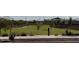 Lush community park featuring grassy areas, young trees, and convenient sidewalks at 25484 W Graham Trl, Buckeye, AZ 85326