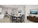 Bright dining room with modern finishes, decorative lighting, and an adjacent kitchen for a convenient flow at 25484 W Graham Trl, Buckeye, AZ 85326