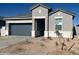 Single-story home featuring a manicured lawn, neutral paint scheme, and a two-car garage in a residential community at 25484 W Graham Trl, Buckeye, AZ 85326