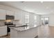 Kitchen with stainless steel appliances, granite countertops, and island seating at 25484 W Graham Trl, Buckeye, AZ 85326