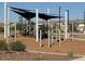 Close up of the playground with black sunshade structure and wood chip base at 25484 W Graham Trl, Buckeye, AZ 85326