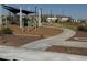 Community playground with shade structure and walking path; great for outdoor recreation at 25484 W Graham Trl, Buckeye, AZ 85326