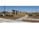 Community playground with shade structures and a walking path in a landscaped area at 25484 W Graham Trl, Buckeye, AZ 85326
