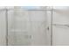 Enclosed shower with light marble and chrome fixtures at 25484 W Graham Trl, Buckeye, AZ 85326