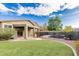 Landscaped backyard showcasing artificial turf, pool with safety fence, and covered patio at 28232 N Abby Cir, San Tan Valley, AZ 85143