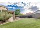 Backyard featuring artificial turf, rock border, pool with safety fence, and covered patio at 28232 N Abby Cir, San Tan Valley, AZ 85143
