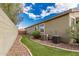 Side yard with artificial turf, rock border, two A/C units and access to back of home at 28232 N Abby Cir, San Tan Valley, AZ 85143