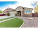 Inviting single-story home with a two-car garage, brick detailing, and low-maintenance landscaping at 28232 N Abby Cir, San Tan Valley, AZ 85143