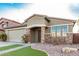 Tan single-story home features a two-car garage, brick accents, and desert landscaping at 28232 N Abby Cir, San Tan Valley, AZ 85143