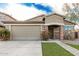 Charming single-story home featuring brick accents, a two-car garage, and manicured landscaping at 28232 N Abby Cir, San Tan Valley, AZ 85143
