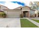 Charming single-story home featuring brick accents, a two-car garage, and manicured landscaping at 28232 N Abby Cir, San Tan Valley, AZ 85143