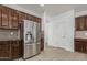 This kitchen features wooden cabinets, granite countertops, stainless steel appliances, and tiled floors and backsplash at 28232 N Abby Cir, San Tan Valley, AZ 85143