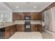 The kitchen offers wooden cabinets, granite countertops, stainless steel fridge, and modern appliances at 28232 N Abby Cir, San Tan Valley, AZ 85143