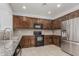 The kitchen offers wooden cabinets, granite countertops, stainless steel fridge, and modern appliances at 28232 N Abby Cir, San Tan Valley, AZ 85143