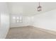 Bright living room with neutral carpet, a modern light fixture, and a tile entryway at 28232 N Abby Cir, San Tan Valley, AZ 85143
