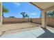 Expansive backyard with gravel and dirt landscaping, a covered patio, and block wall fencing at 30100 N Sunray Dr, San Tan Valley, AZ 85143