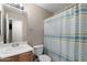 Bathroom featuring a vanity with sink, toilet and shower with blue and white curtain at 30100 N Sunray Dr, San Tan Valley, AZ 85143