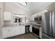 Bright kitchen with white cabinets, stainless steel appliances, and tile backsplash at 30100 N Sunray Dr, San Tan Valley, AZ 85143