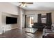 Open living space with wood-look tile, access to backyard, and neutral walls at 30100 N Sunray Dr, San Tan Valley, AZ 85143
