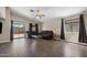 Spacious living room with wood floors, large windows, and sliding door access to the yard at 30100 N Sunray Dr, San Tan Valley, AZ 85143